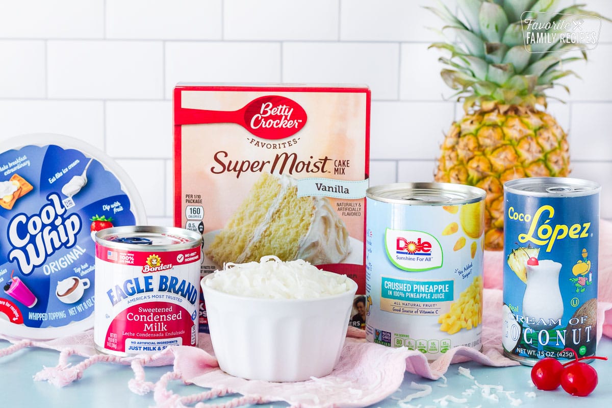 Cool whip, cake mix, sweetened condensed milk, can of crushed pineapple, can of cream of coconut, coconut, pineapple and cherries to make Pina Colada Cake.