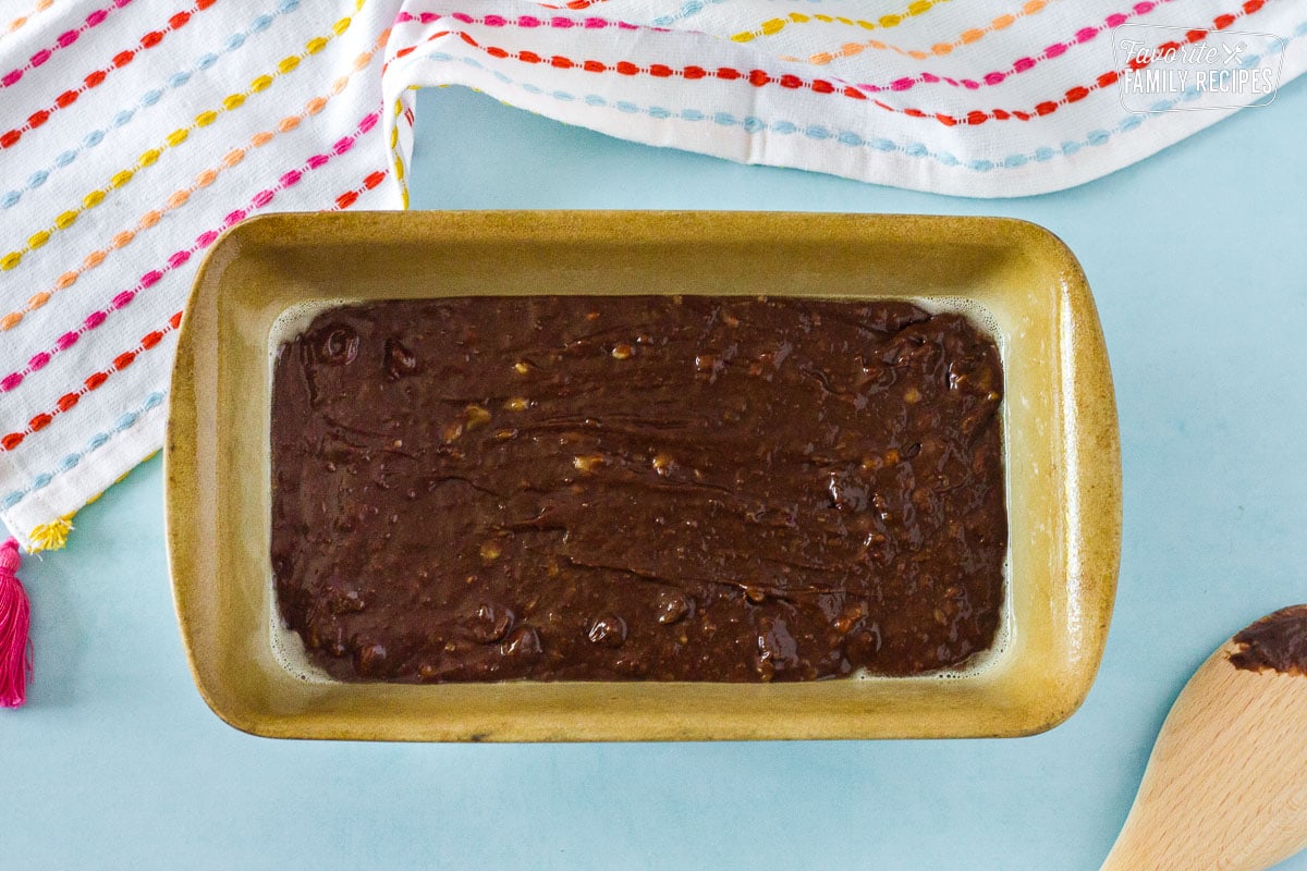 Chocolate Banana Bread batter in a greased loaf pan.