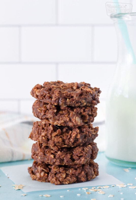 Stack of five No Bake Cookies. Tall glass of milk on the side.