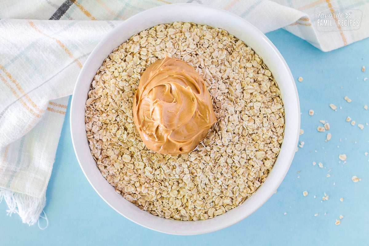 Bowl of oatmeal, peanut butter and vanilla to make No Bake Cookies.