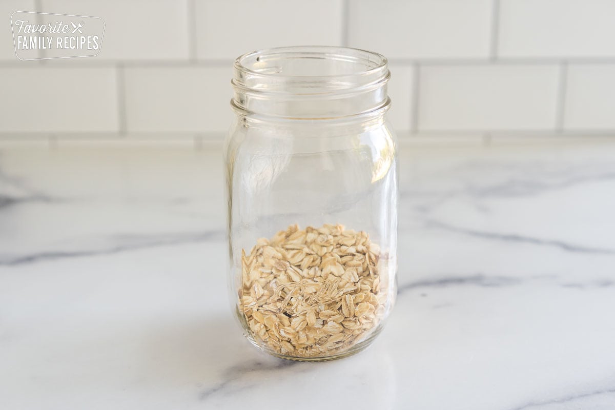 Oats in the bottom of a glass jar.