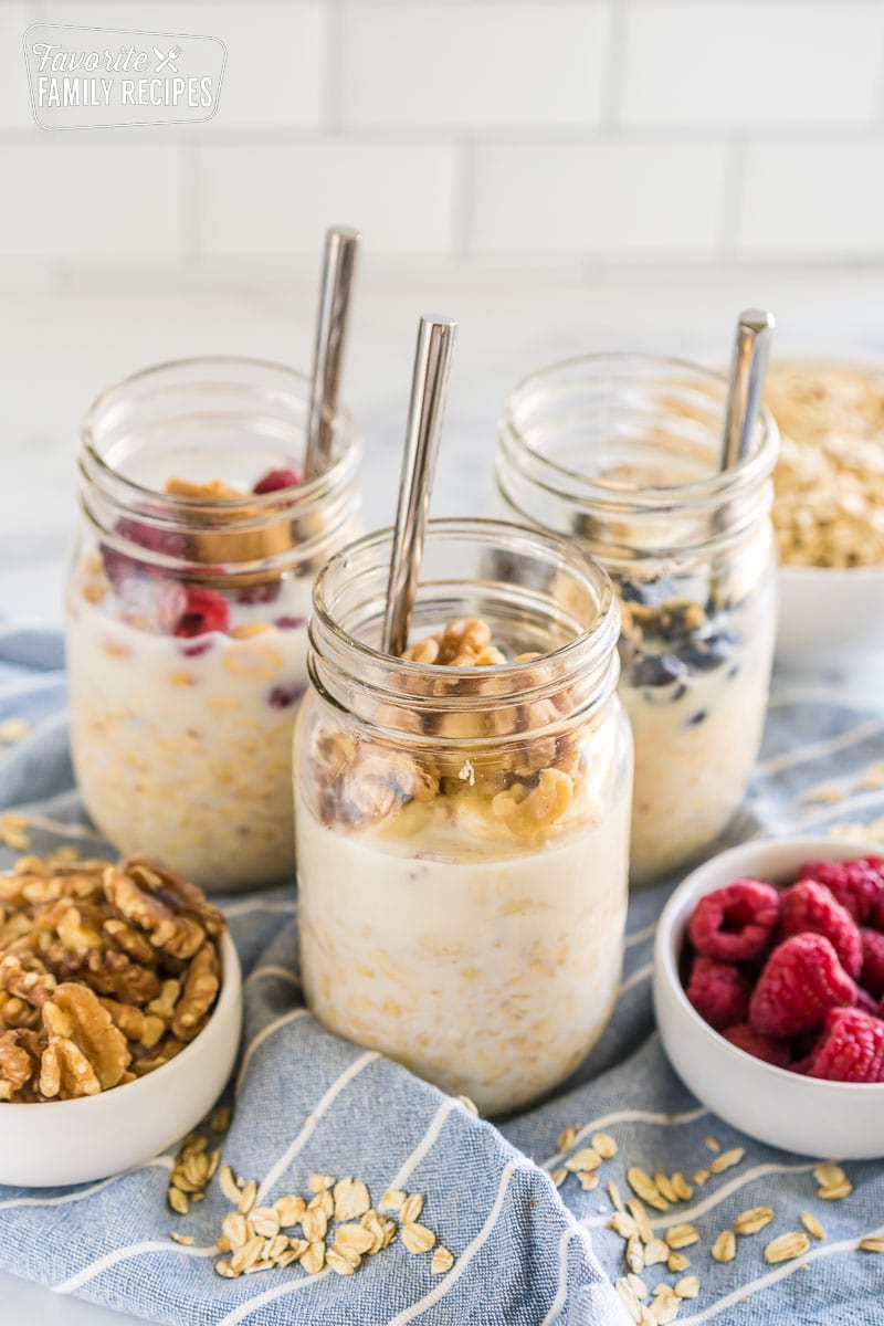 Overnight oats in mason jars with spoons sticking out.