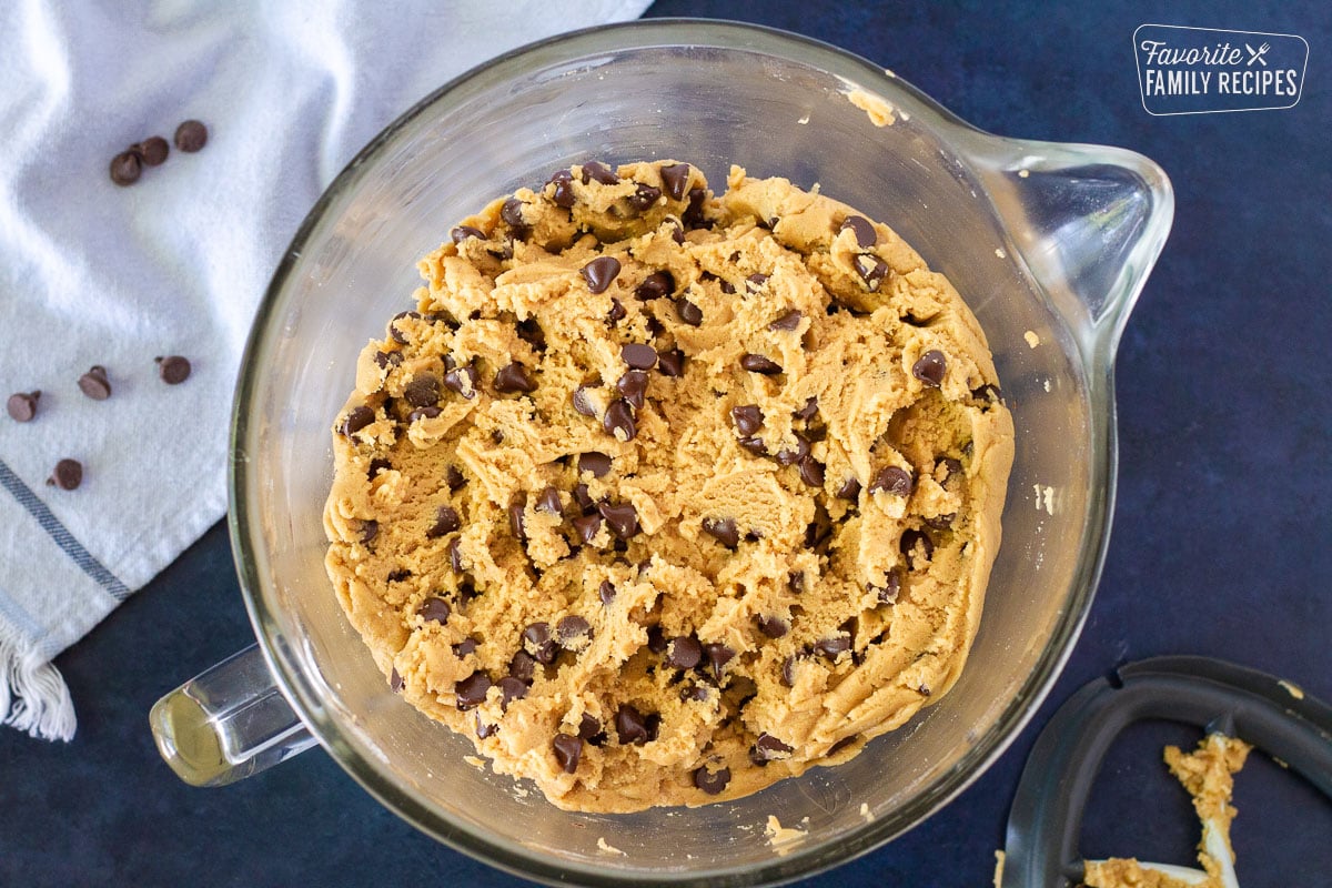 Glass mixing bowl of Peanut Butter Chocolate Chip Cookie dough.