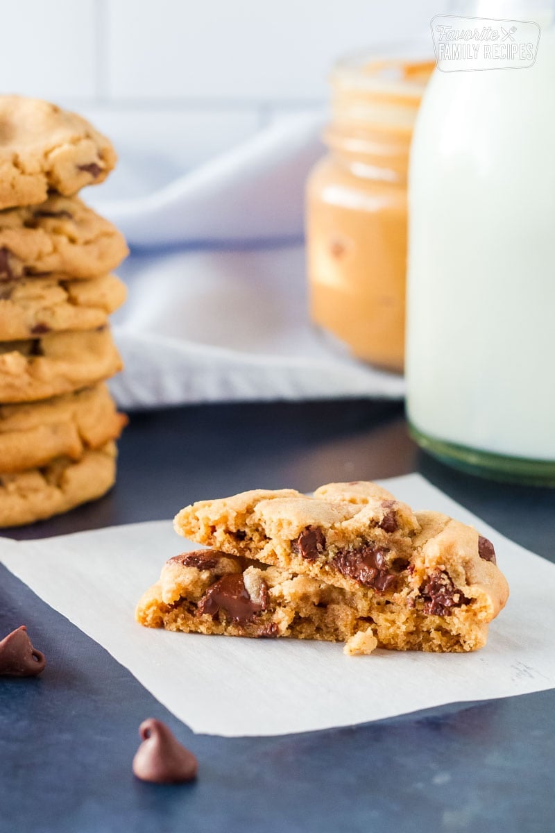 One Peanut Butter Chocolate Chip Cookie cut in half with melty chocolate chips.