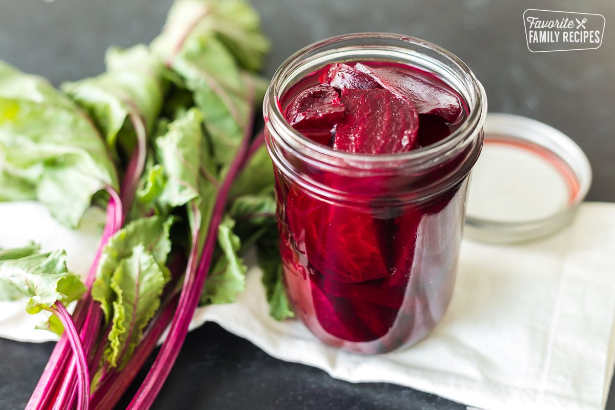 A clear jar filled with pickled beets