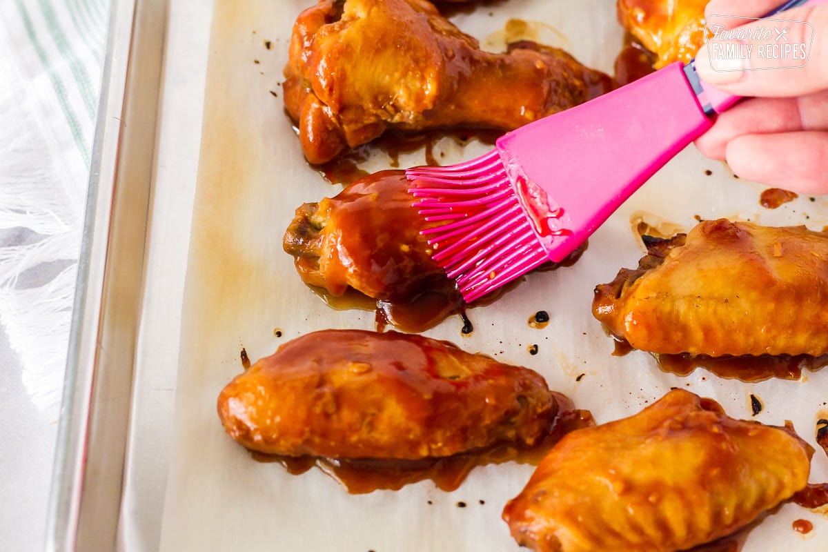 Brush basting chicken wings with sauce for Hot Wings with Blue Cheese Dressing.
