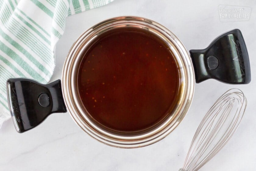 Pan with sauce and whisk for Hot Wings with Blue Cheese Dressing.