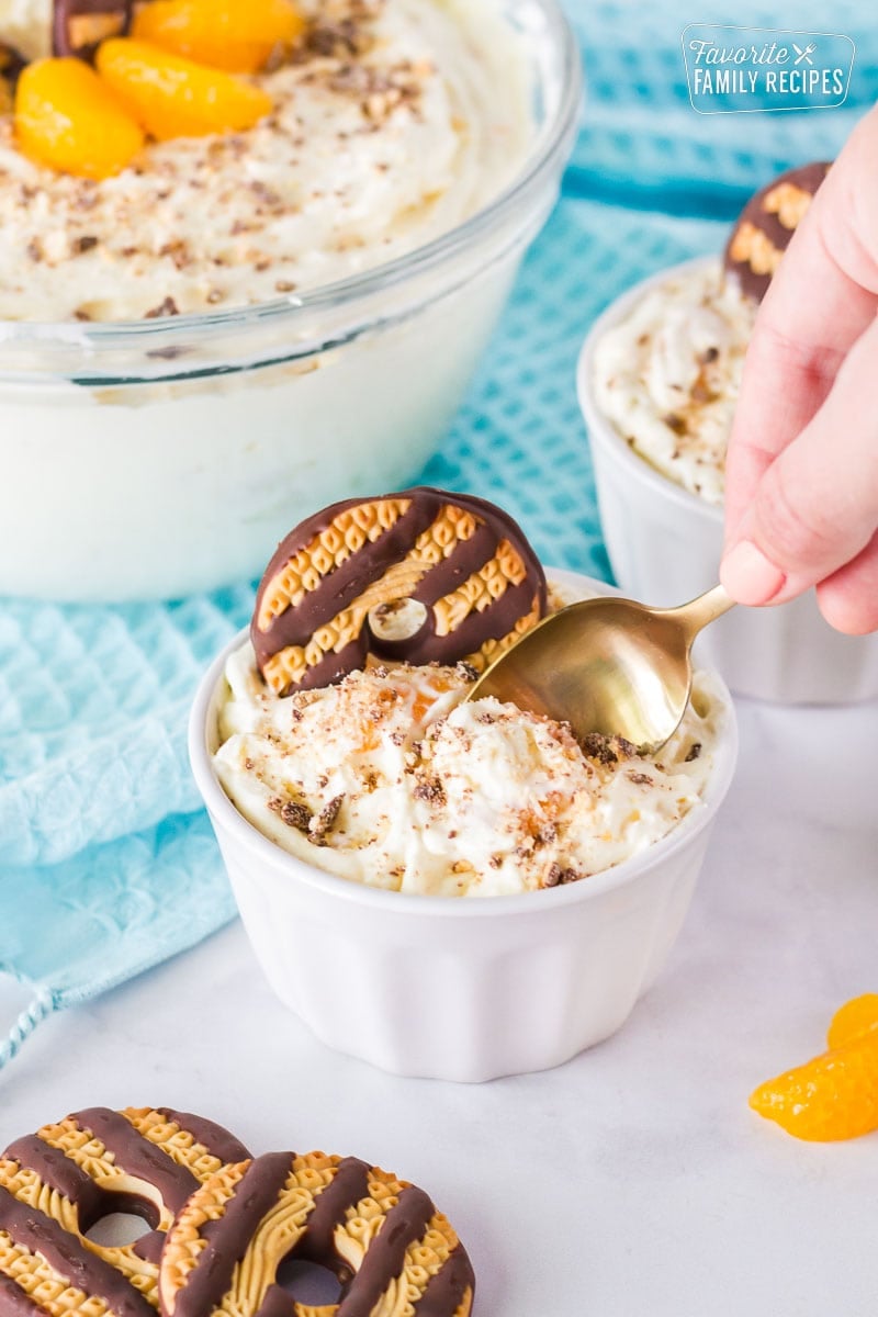 Golden spoon scooping out cookie salad from the serving bowl.