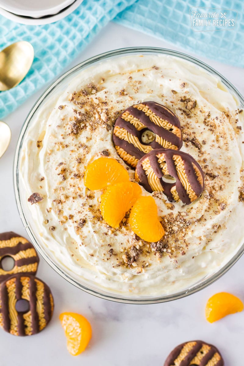 This cookie salad is one of my favorite summertime desserts. It’s not your typical potluck “salad” but trust me, your guests won’t mind one bit! Top view of Cookie Salad with fudge stripe cookies and mandarin oranges on top.
