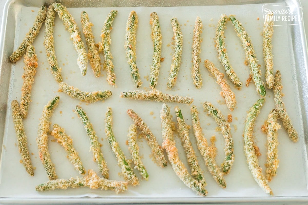 Breaded green beans on a baking sheet.