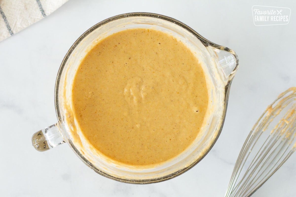 Bowl of Pumpkin Pancake batter. Whisk on the side.