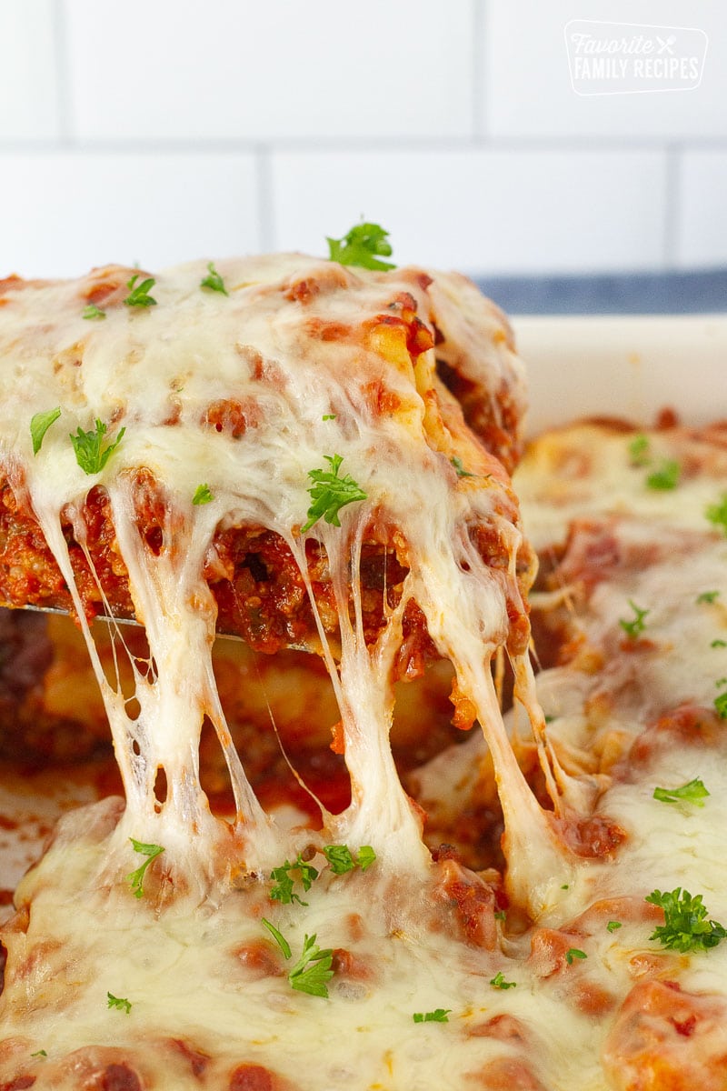 Cheese stretching from a Lasagne Roll Up lifted out of the dish with a spatula.