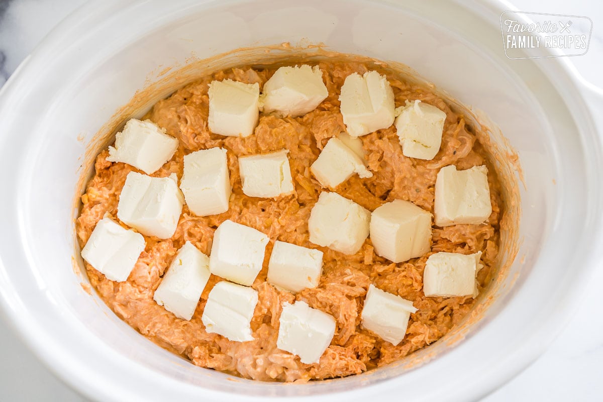 Buffalo chicken dip in the crock pot with cream cheese cubes