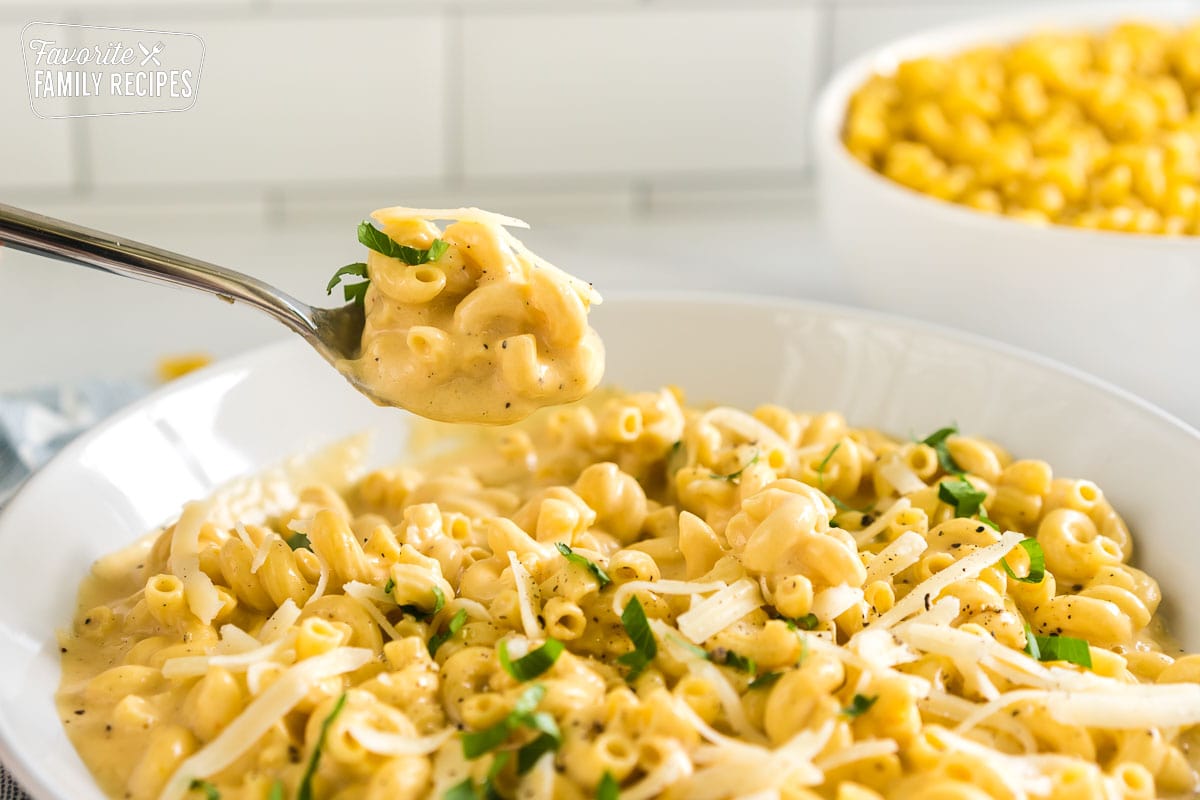 A spoonful of mac and cheese made in a crock pot.