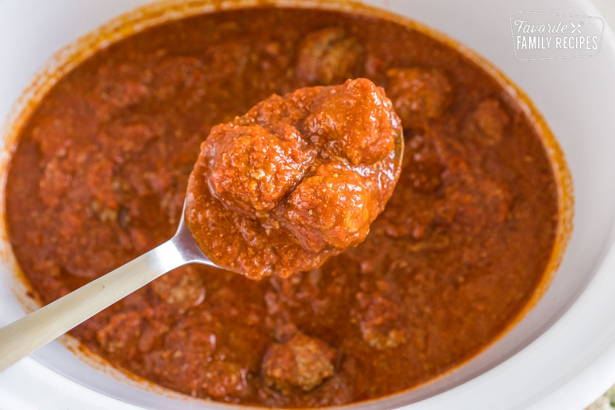 A spoonful of meatballs and sauce.