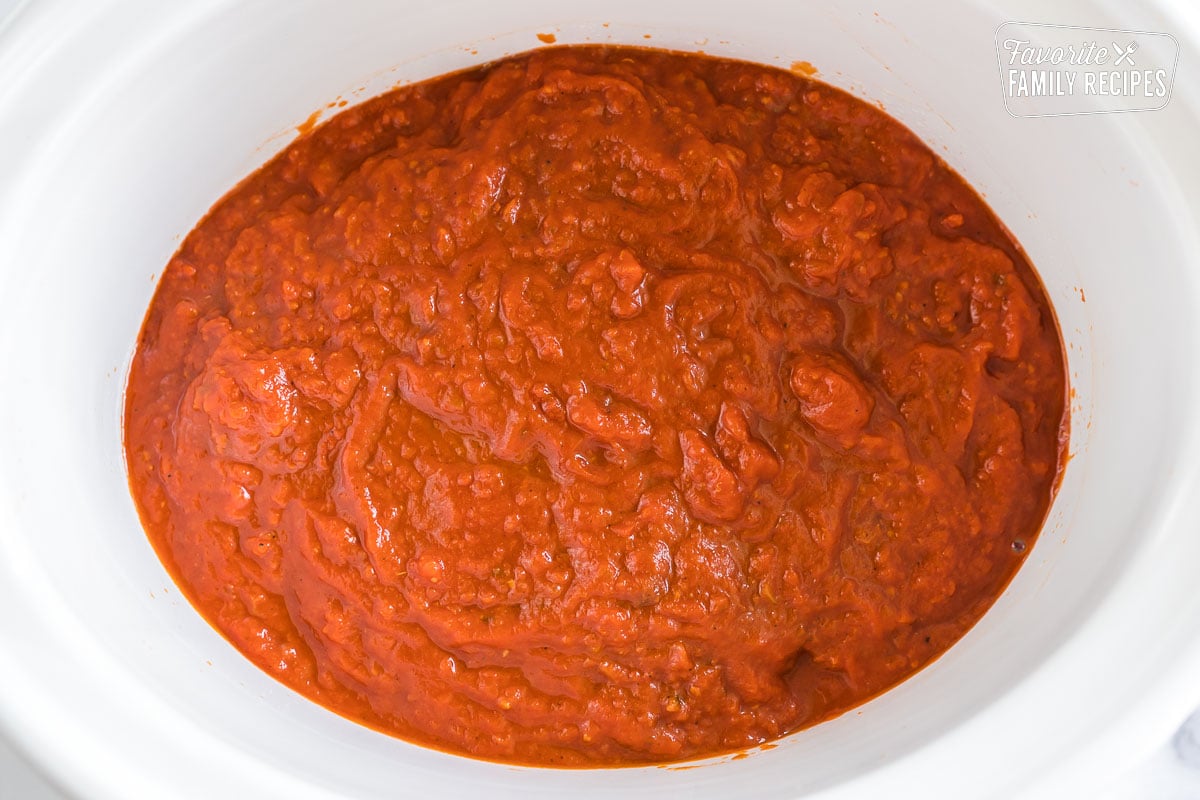Marinara sauce poured over meatballs in a crockpot