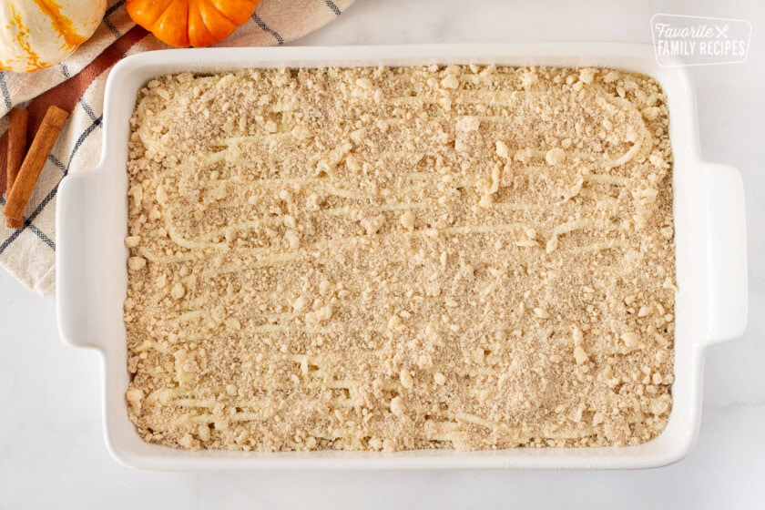 Baking dish of Pumpkin Coffee Cake with crumb topping.