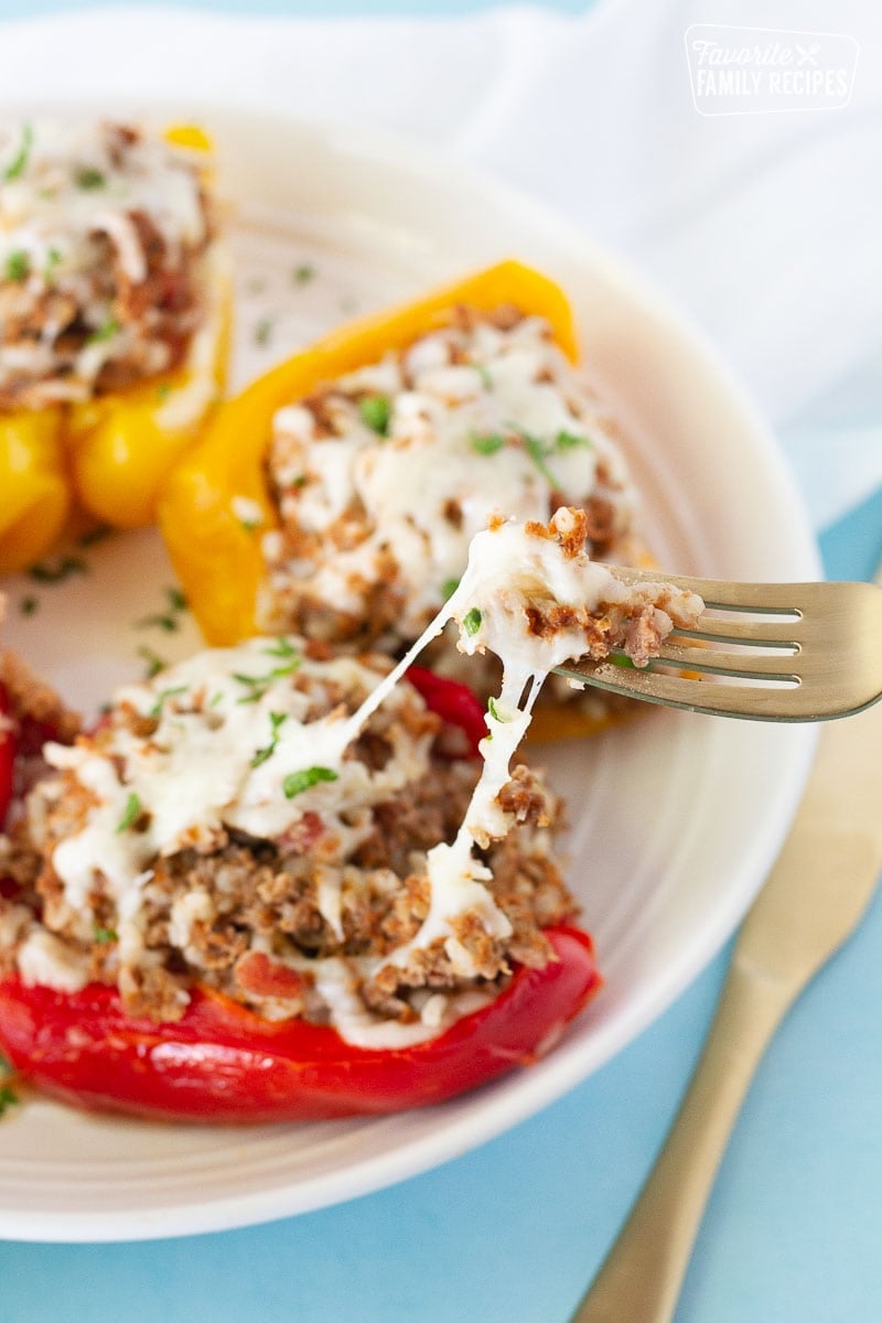 Fork stretching some cheese for a bite of Instant Pot Stuffed Peppers.