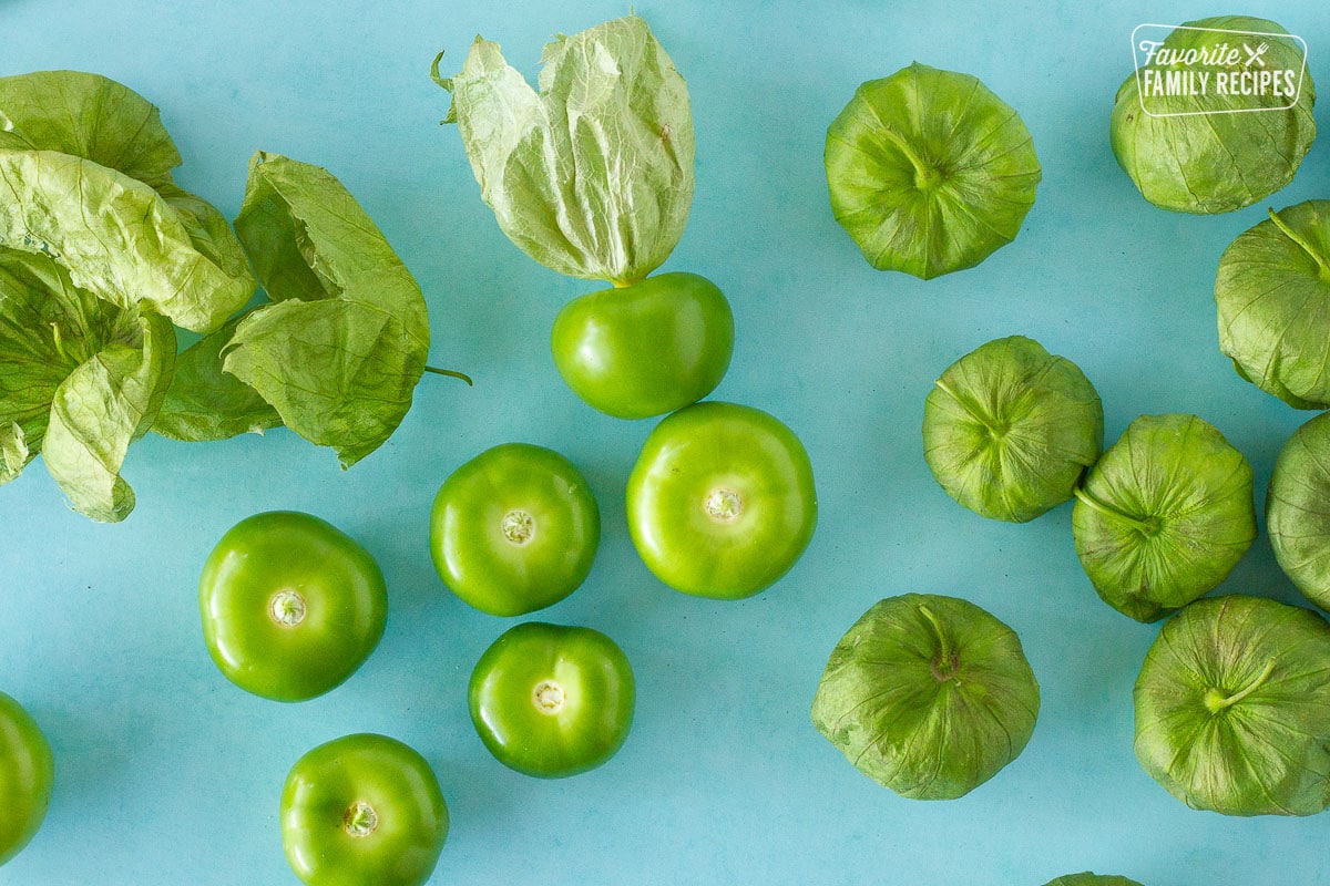 Husked and unhusked fresh tomatillos for Tomatillo Salsa Verde.