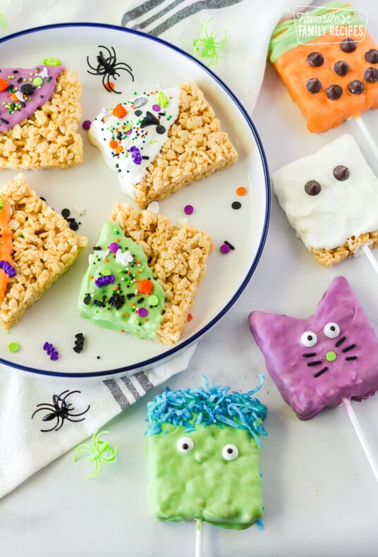 Halloween Rice Krispie treats in the shape of a pumpkin, ghost, cat, and Frankenstein