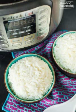 Instant Pot rice separated into two bowls next to an Instant Pot