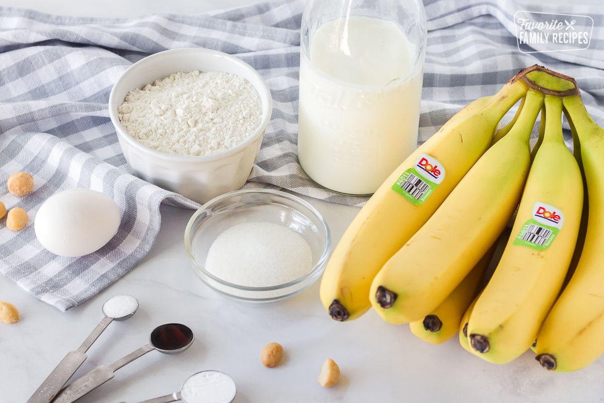 Bananas, buttermilk, flour, sugar, egg, and a measuring spoon of vanilla, baking soda and salt to make Banana Pancakes.