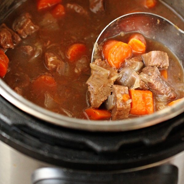 Instant Pot Beef Goulash being ladled from an Instant Pot
