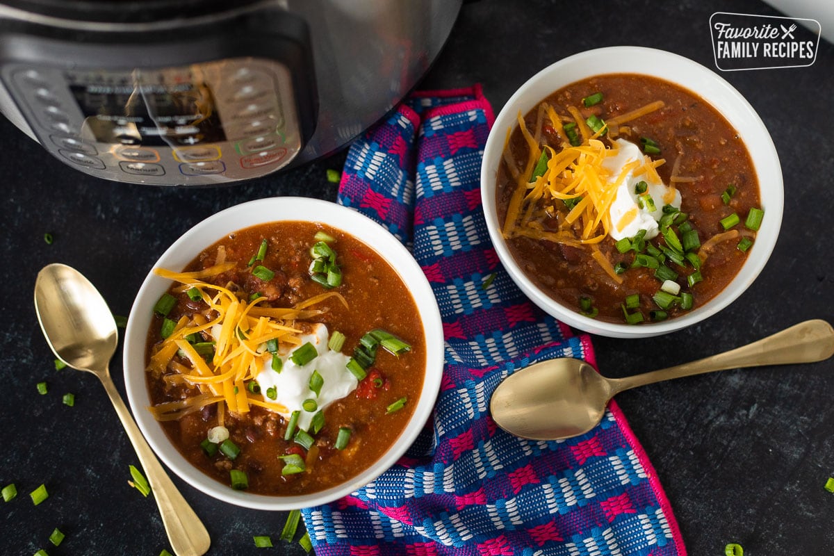 Two bowls of Instant Pot chili with toppings