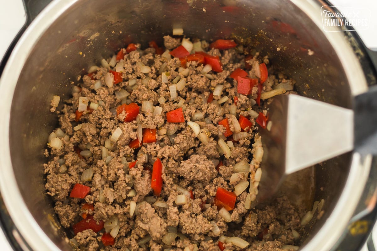 Cooked ground beef with onions and peppers in an Instant Pot.