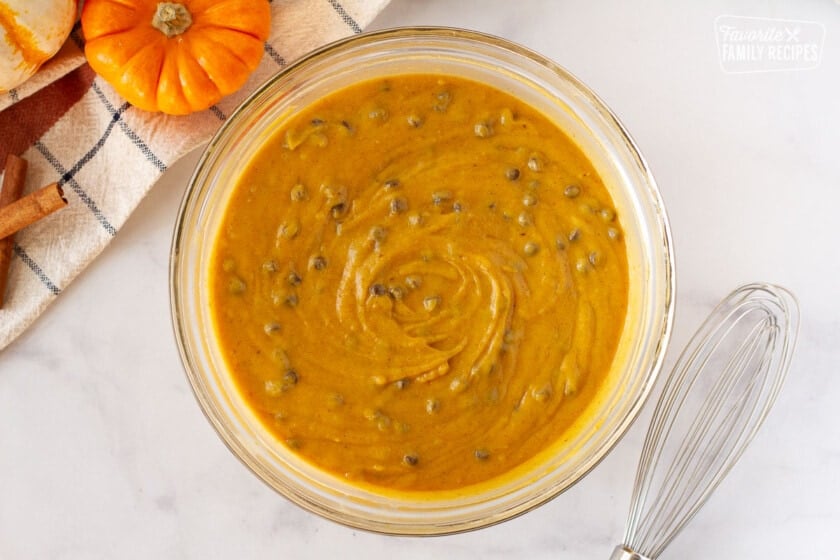 Bowl of Pumpkin Coffee Cake batter with a whisk on the side.