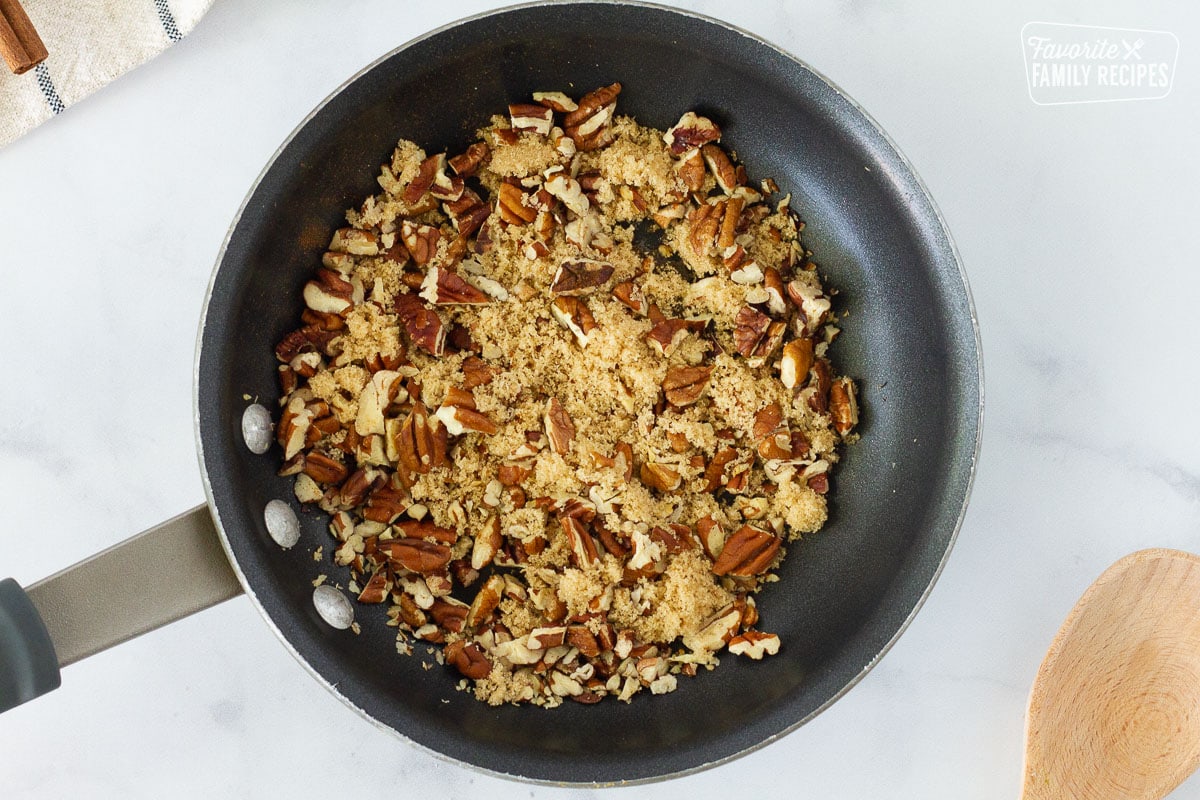 Brown sugar and chopped pecans in a skillet to make topping for Pumpkin Pancakes.