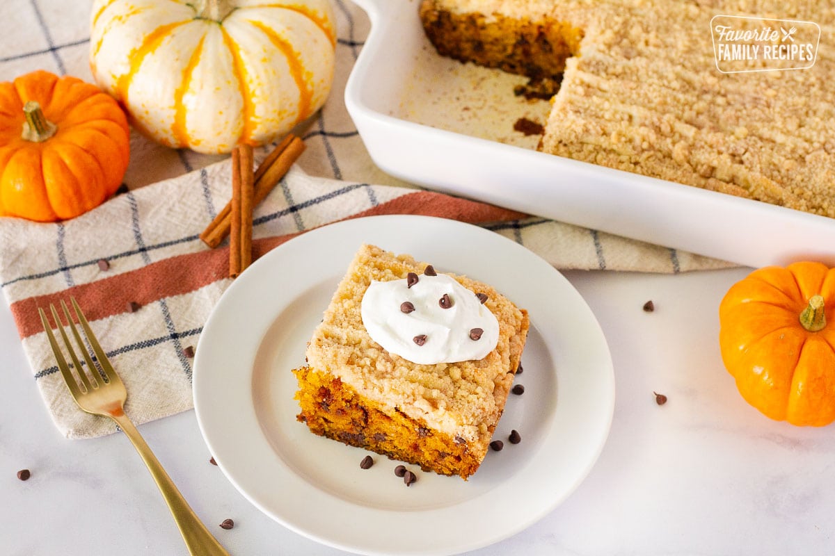 Slice of Pumpkin Coffee Cake on a plate with the baking dish inn the background.