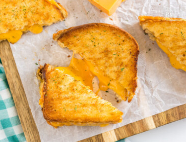 A grilled cheese sandwich that has been cooked in an air fryer cut in half