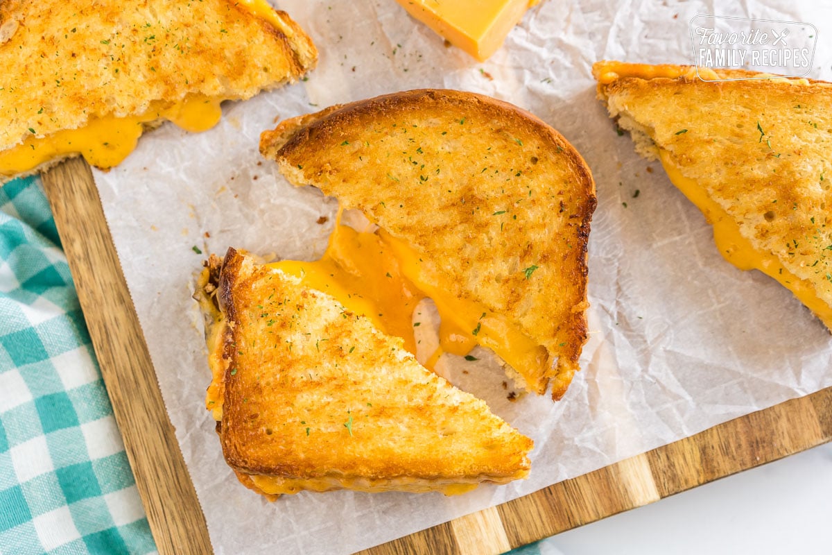 A grilled cheese sandwich that has been cooked in an air fryer cut in half.