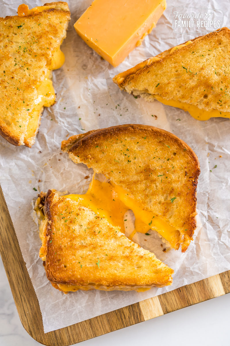 A grilled cheese sandwich that has been cooked in an air fryer cut in half.