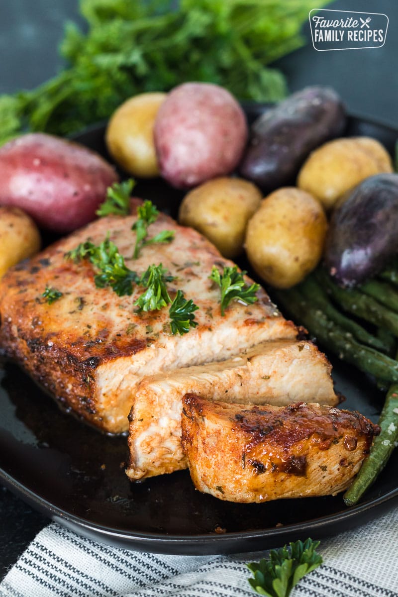 Slices of an air fryer pork chop on a plate.