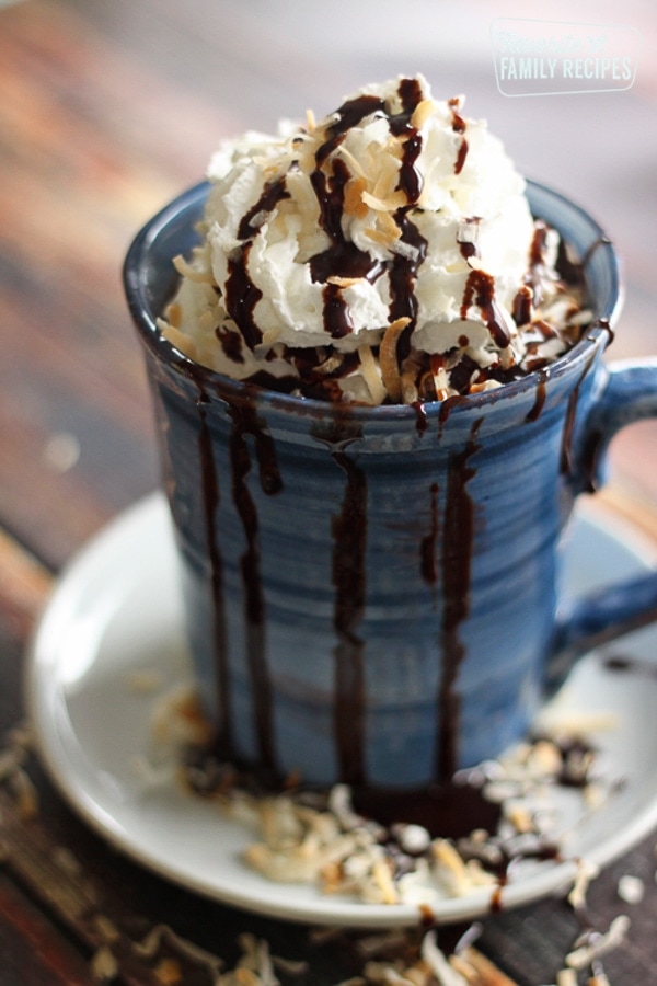 In a blue mug, almond joy candy bar hot chocolate.