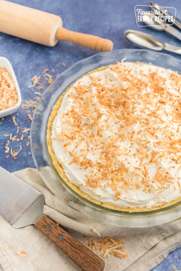 A whole coconut cream pie with toasted coconut on top.