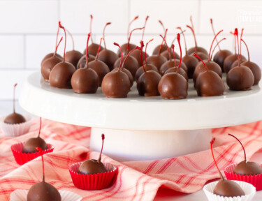 Stand with Chocolate Covered Cherries and other Chocolate Covered Cherries in mini cupcake liners.