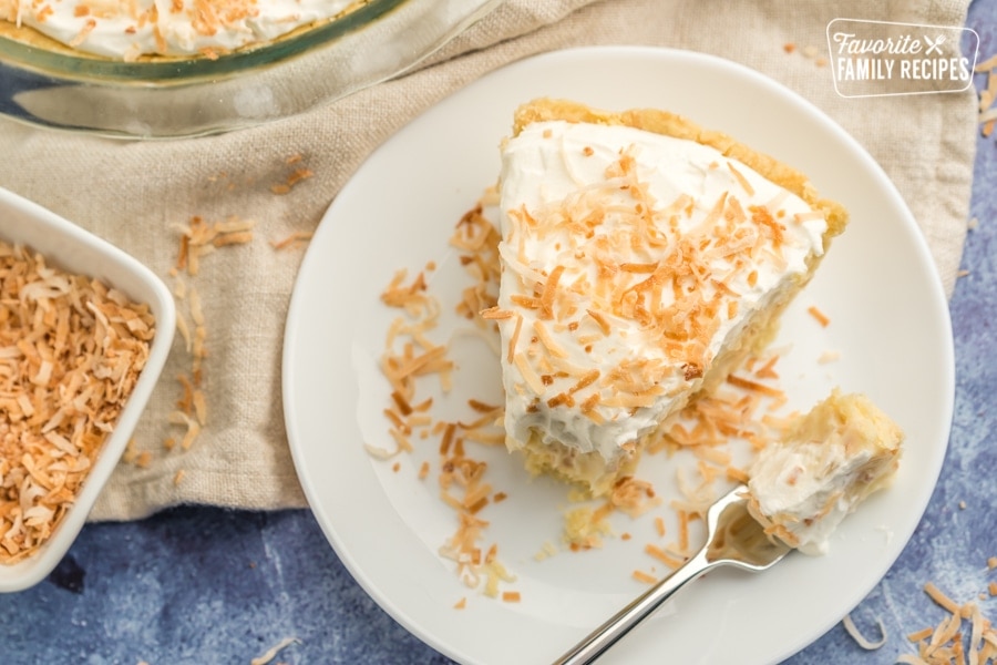 Top view of a slice of coconut cream pie with toasted coconut on top.
