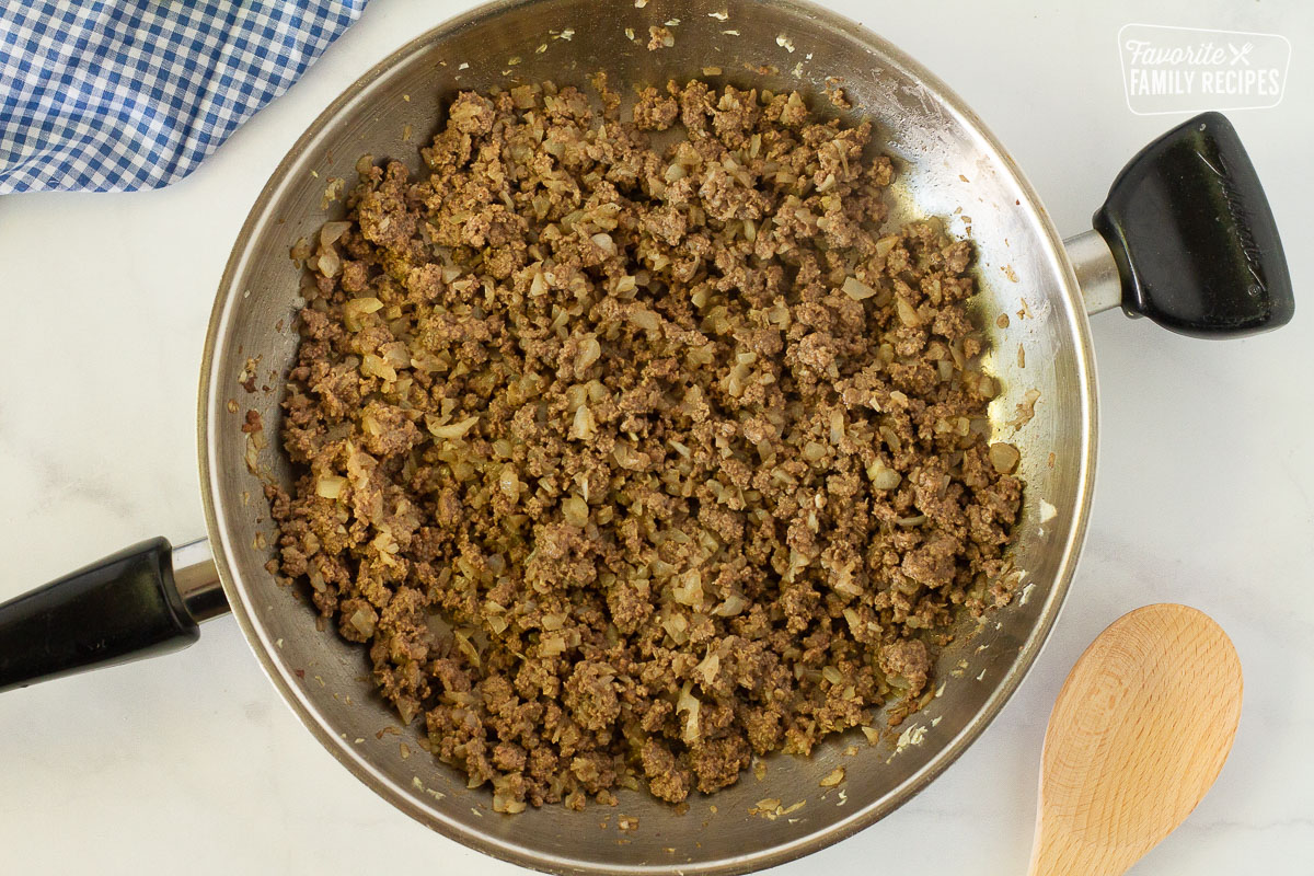 Skillet with cooked ground beef and onions for Easy Shepherd's Pie.