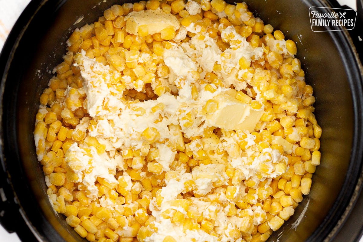 Crockpot of corn, unmelted butter, cream cheese, salt and pepper.