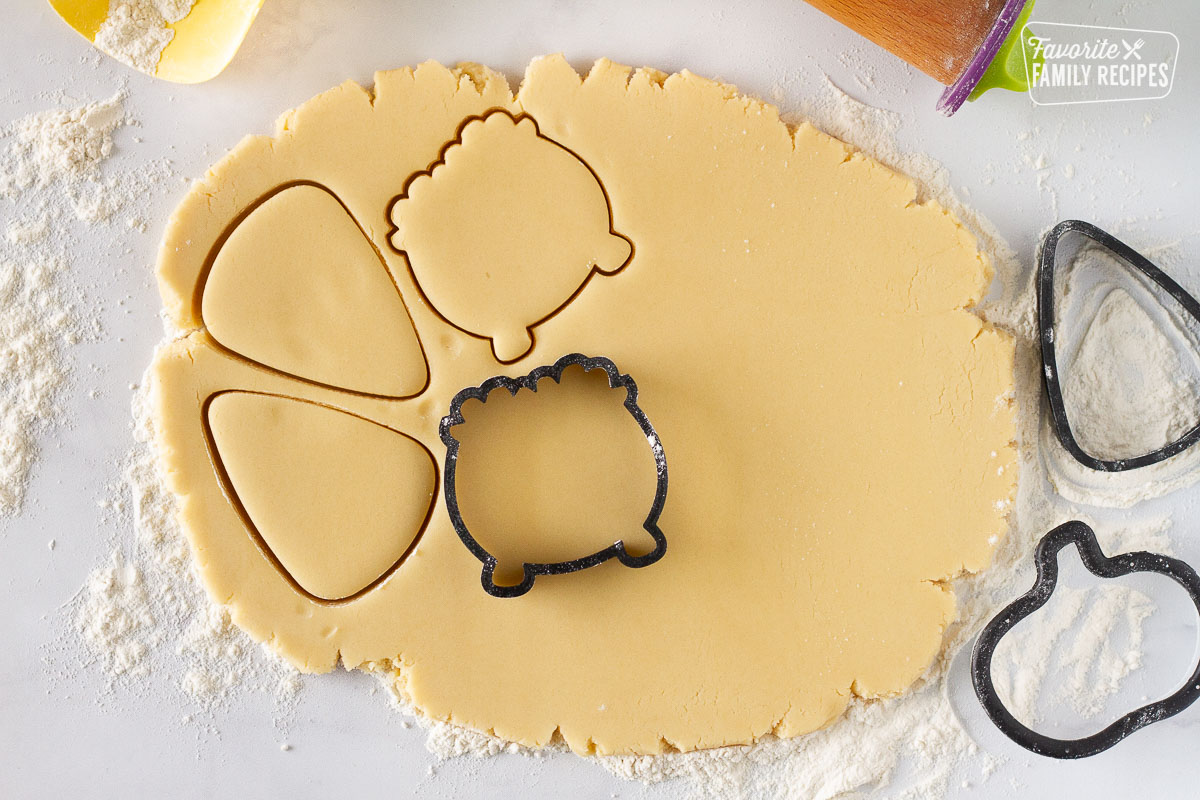 Cut out shapes of candy corn and cauldrons to make Halloween Cookies.