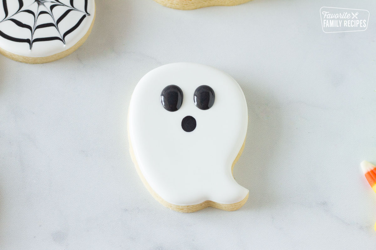Decorated Ghost Halloween Cookie with large black eyes.