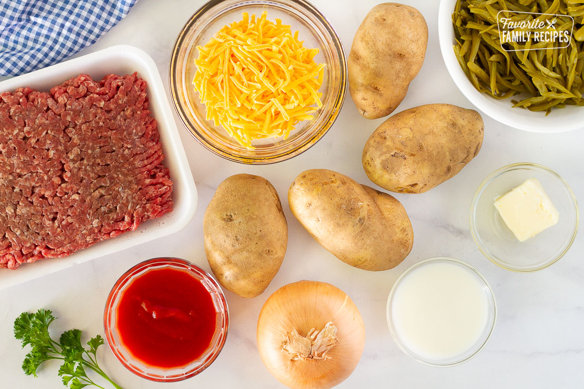 Ground beef, potatoes, cheese, green beans, butter, milk, onion and tomato sauce to make Easy Shepherd's Pie.