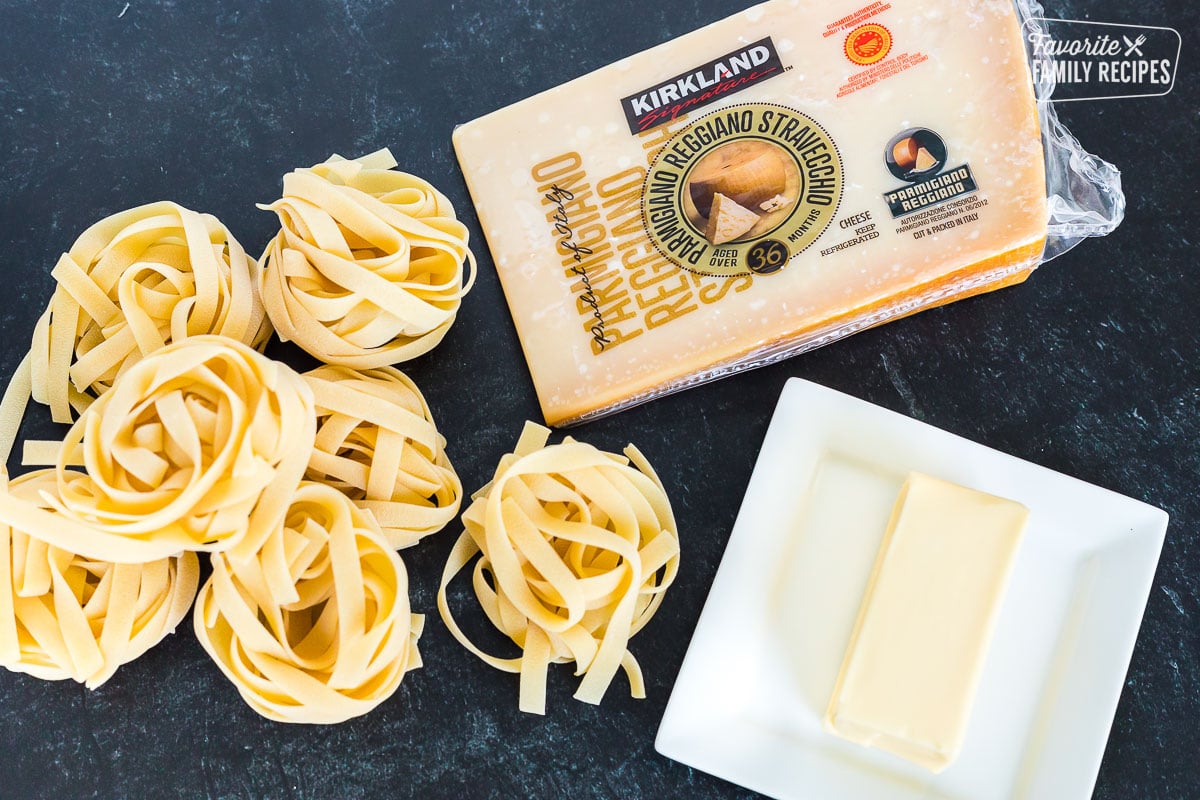 Ingredients to make Fettuccine Alfredo including pasta noodles, butter, and Parmigiano Reggiano
