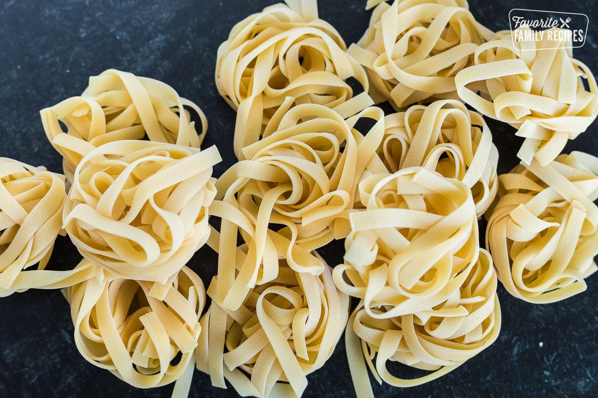 Dried fettuccine noodles formed into nests