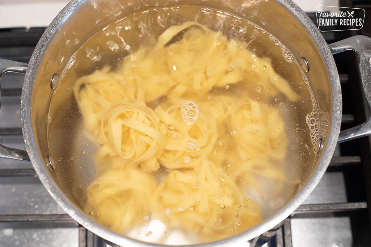 Fettuccine noodles in a pot of boiling water