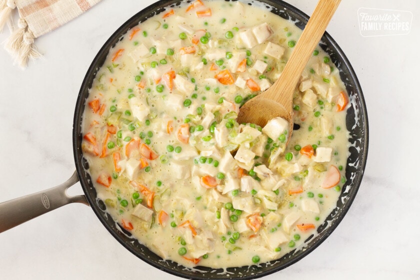Filling of Easy Turkey Pot Pie with vegetables and gravy in a skillet.