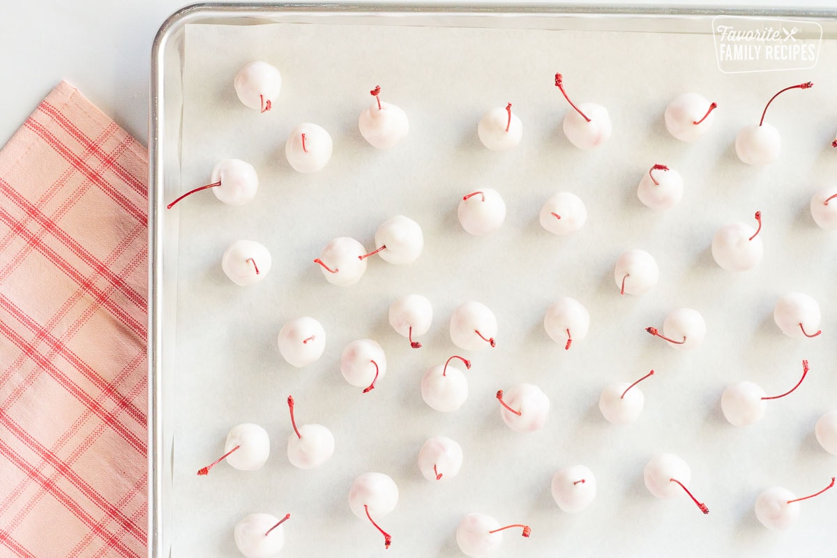 Baking sheet of fondant covered cherries for Chocolate Covered Cherries.